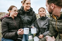 Camping family having morning drinks