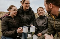 Camping family having morning drinks