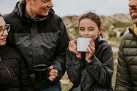 Camping family having morning drinks