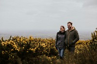 Happy couple walking in flower field