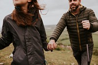 Father & daughter holding hands while hiking