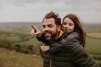 Daughter on father's shoulders, happy family