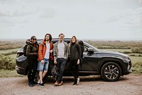 Friends enjoying road trip on hill photo