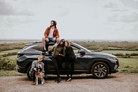 Friends enjoying road trip on hill photo