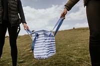 Blue cooler bag held by female hikers photo