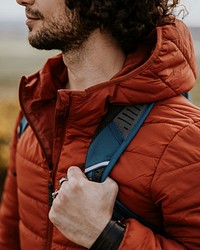 Man wearing jacket & backpack for outdoor activity photo