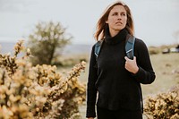 Woman hiking on hill, outdoor activity photo