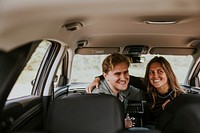 Happy couple taking photo in car photo