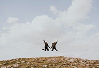 Female hikers jumping together, outdoor activity