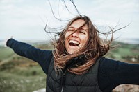 Smiling woman spreading arms, outdoor activity