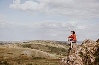 Man sitting on the edge of a cliff photo