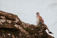 Man sitting on the edge of a cliff photo