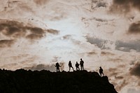 Silhouette of hikers walking on mountain