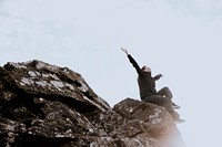 Woman sitting on the edge of a cliff photo