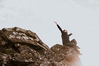 Woman sitting on the edge of a cliff photo