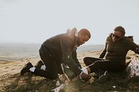 Man putting bandage on woman's leg photo