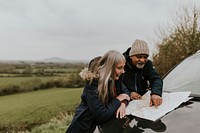 Senior couple looking at map, outdoor travel
