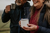 Senior camping couple drinking coffee