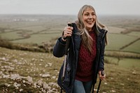 Senior woman hiking mountain, countryside, outdoor travel