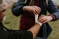 Woman wrapping elastic bandage, first aid