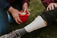 Woman wrapping elastic bandage, first aid