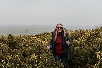 Senior woman trekking through flower field