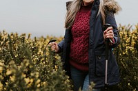 Senior woman trekking through flower field