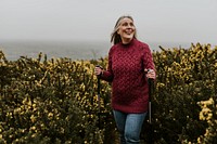 Senior woman trekking through flower field