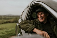 Senior man looking out car window