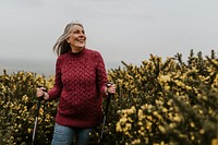 Senior woman hiking through flower field