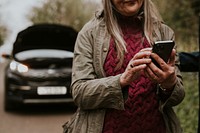 Woman calling mechanic, car broken down