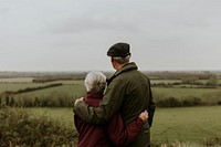 Senior couple hugging, outdoor travel photo