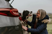 Woman petting her dog, outdoor travel