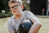 Cheerful boy holding a football