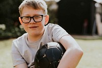 Cheerful boy holding a football