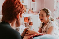 Girl with Down Syndrome and mother playing