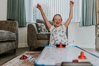 Girl with Down Syndrome playing air hockey