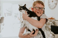 Little boy hugging his cat