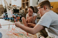 Happy siblings playing buzz wire game