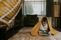 Little boy playing game on tablet