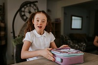 Down syndrome girl packing lunch bag