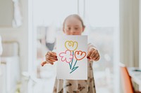 Girl showing flower drawing, art activity