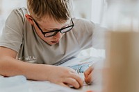 Little boy coloring his book, education photo