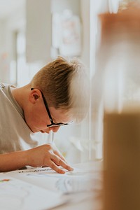 Little boy coloring his book, education photo