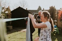Down syndrome girl hanging laundry, house chore