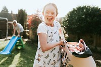 Happy girl with down syndrome helping with laundry