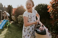 Girl with Down Syndrome doing laundry, house chore