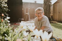Little boy planting flower, gardening hobby