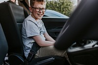 Boy sitting in car backseat