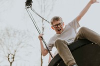 Happy boy having fun, playground photo